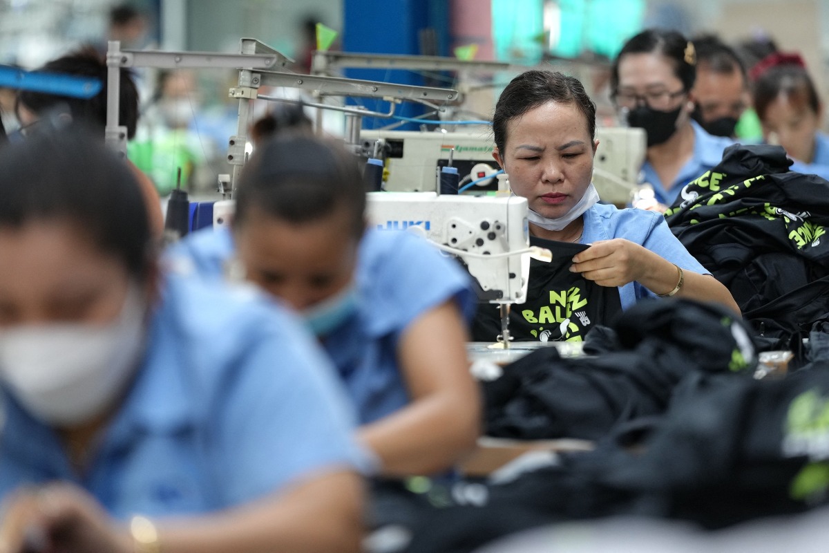 Vietnamese garment factory workers stitch apparel at a factory in Ho Chi Minh City on April 3, 2025, after US President Donald Trump unveiled sweeping new tariffs on trading partners. Photo by Huu Kha / AFP