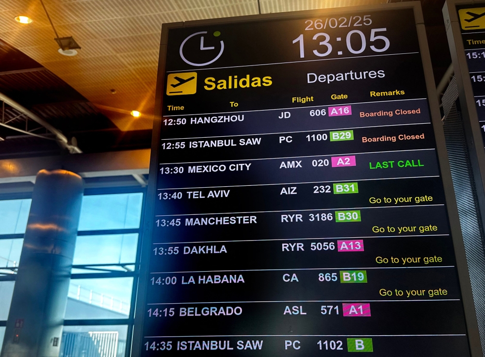 This picture taken on February 26, 2025 shows a flight information display at Madrid Barajas airport. (Photo by WAFAA ESSALHI / AFP)