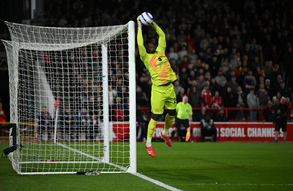 Manchester United's Cameroonian goalkeeper #24 Andre Onana saves a shot during the English Premier League football match between Nottingham Forest and Manchester United at The City Ground in Nottingham, central England, on April 1, 2025. (Photo by Paul ELLIS / AFP) 