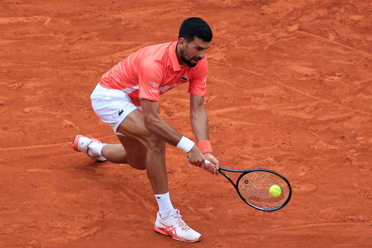 Serbia's Novak Djokovic plays a backhand return to Chile's Alejandro Tabilo during the Monte Carlo ATP Masters Series Tournament round of 32 tennis match on the Ranier III court at the Monte Carlo Country Club in Roquebrune-Cap-Martin on April 9, 2025. (Photo by Valery HACHE / AFP)
