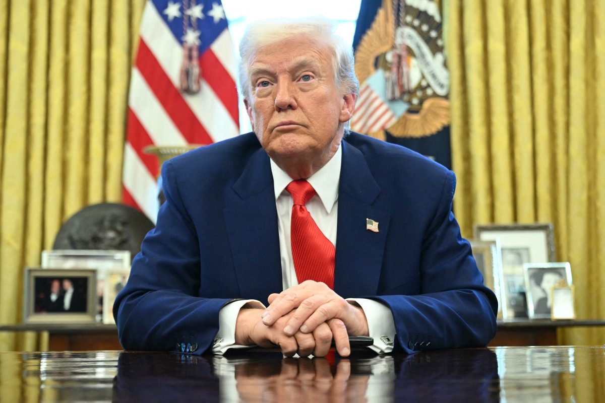 US President Donald Trump looks on after signing an executive order in the Oval Office of the White House on April 9, 2025 in Washington, DC. (Photo by SAUL LOEB / AFP)