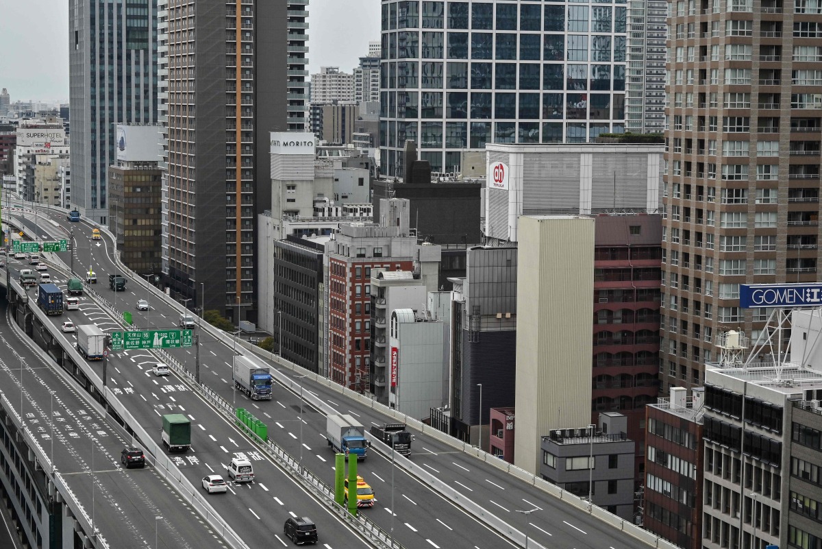 This general view shows an elevated expressway alongside highrise buildings in downtown Osaka on April 10, 2025. (Photo by Richard A. Brooks / AFP)
