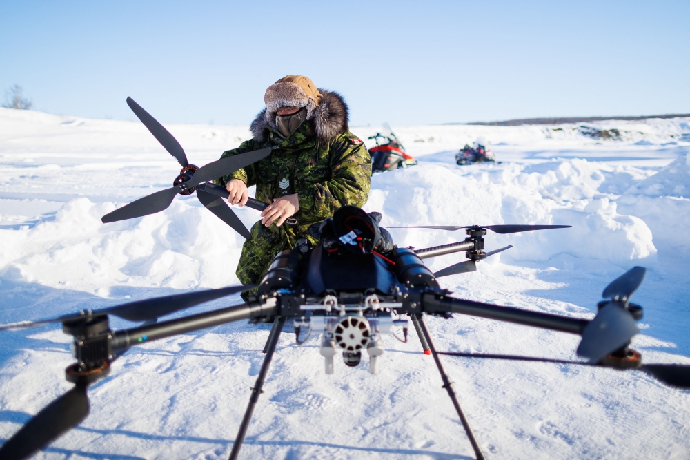 A Canadian soldier dismantles a drone as a team from the Canadian Navy test thermal imaging drone capabilities in Arctic environments, during Operation Nanook, the Canadian Armed Forces' annual Arctic training and sovereignty operation, in Inuvik, Northwest Territories, Canada, February 27, 2025. (Photo by Cole Burston / AFP)
 