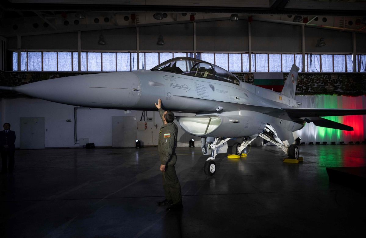 A Bulgarian pilot touches the first Bulgarian F-16 Block 70 fighter aircraft after a ceremony marking it's arrival at Graf Ignatievo airbase on April 13, 2025. Photo by Nikolay DOYCHINOV / AFP