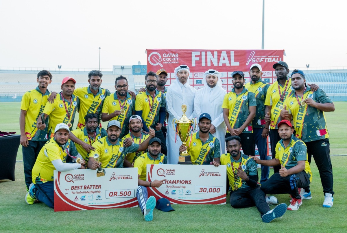 QB 11 Stars' players and officials celebrate with the trophy. 