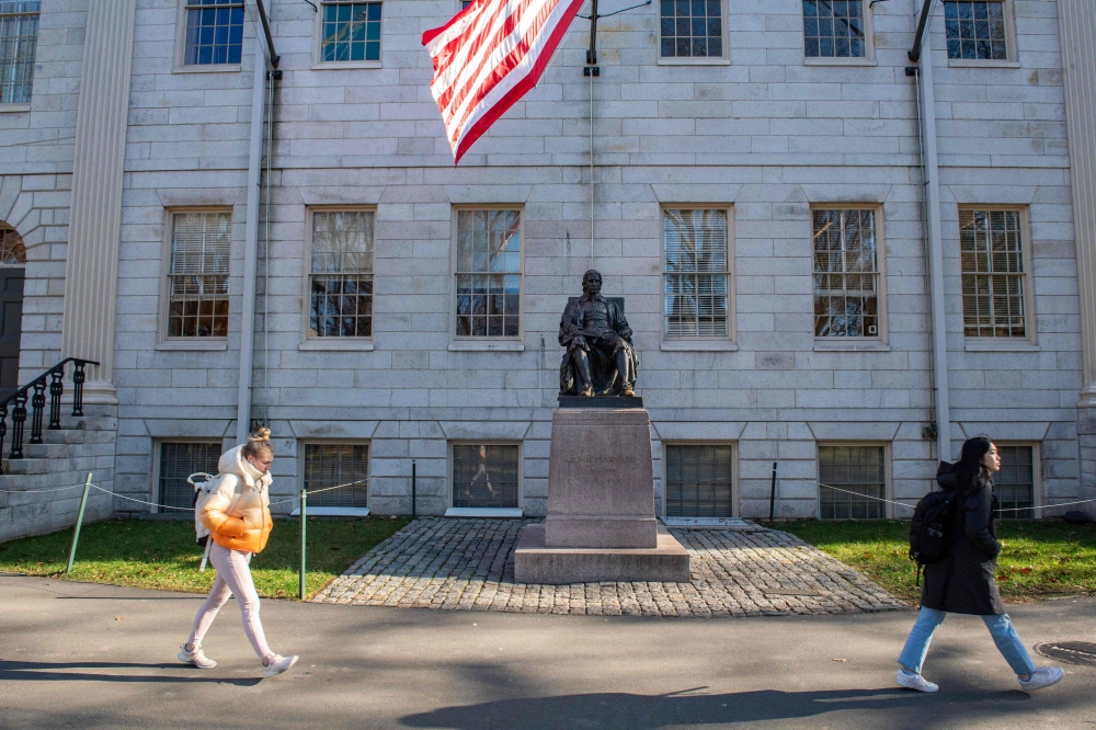 People walk through Harvard Yard at Harvard University in Cambridge, Massachusetts, on December 12, 2023. (Photo by Joseph Prezioso / AFP)
 