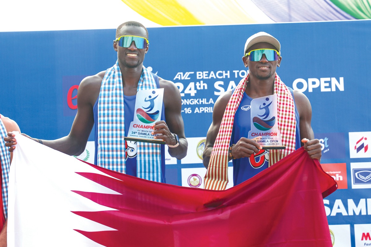 Cherif Younousse (left) and Ahmed Tijan celebrate with the Qatari flag after sealing the title.  