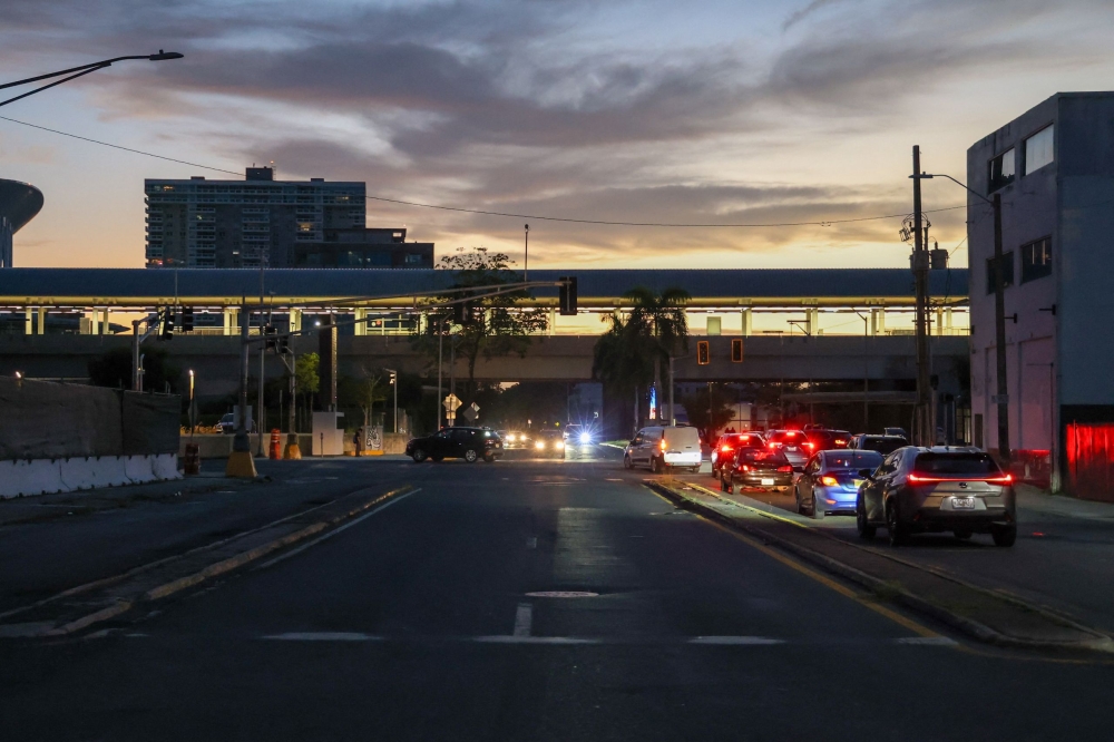 People drive their cars during a massive power blackout in Old San Juan, Puerto Rico, on April 16, 2025. (Photo by Jaydee Lee Serrano / AFP)
 