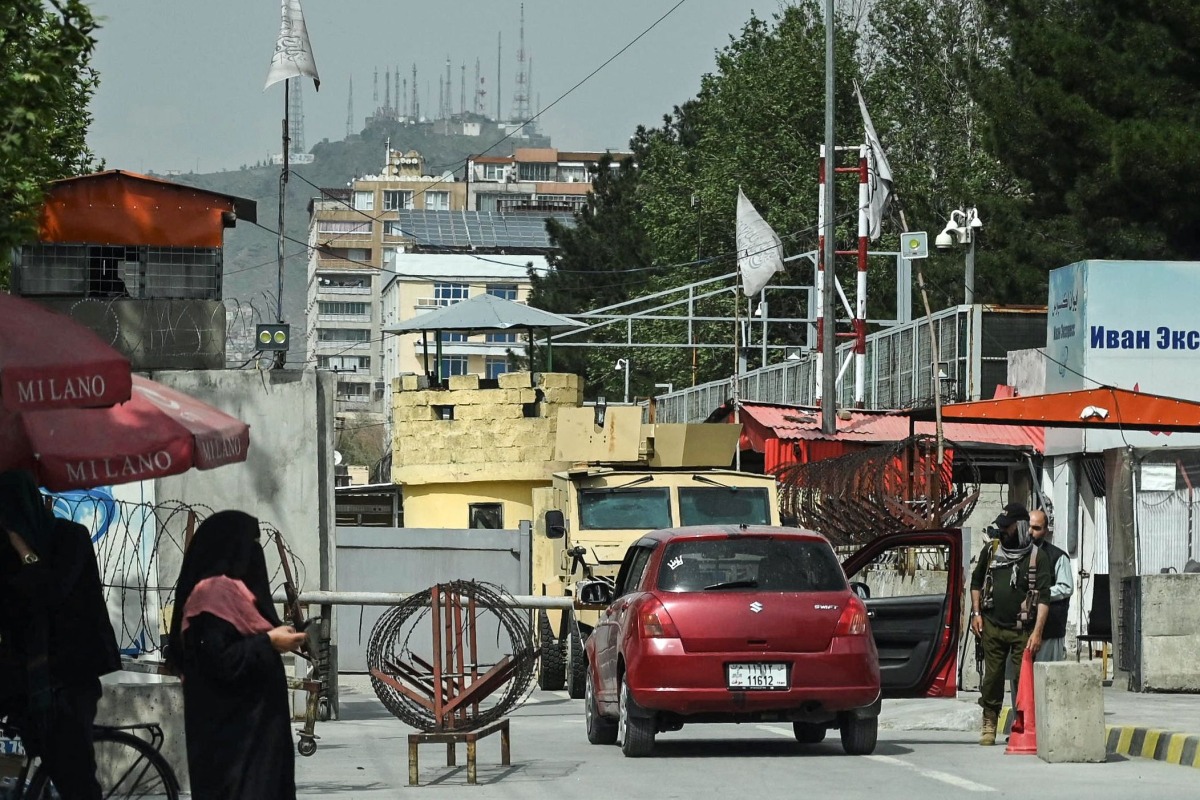 A Taliban security personnel (R) inspects a vehicle at the entrance of the Embassy of Russia in Kabul on April 17, 2025. (Photo by Wakil Kohsar / AFP)
