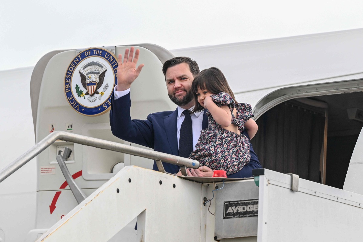 U.S. Vice President JD Vance disembarks Air Force Two while carrying his daughter Mirabel, upon arriving at Rome Ciampino Airport, on April 18, 2025. The US Vice President will meet with Prime Minister Giorgia Meloni and will also meet with Vatican Secretary of State Cardinal Pietro Parolin. (Photo by Kenny HOLSTON / POOL / AFP)
