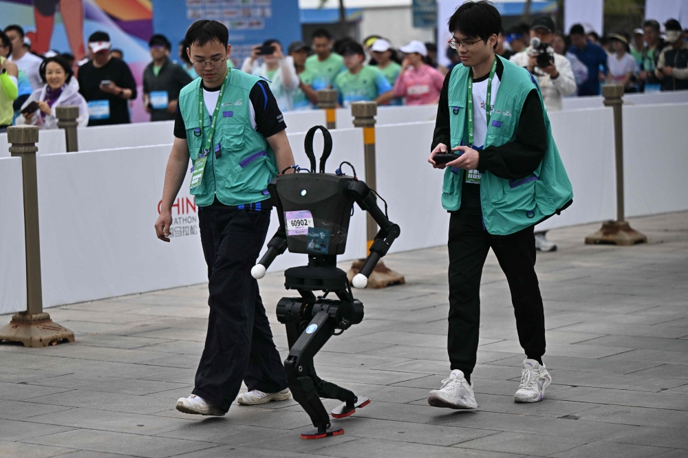 A robot takes part in the humanoid robot half marathon in Beijing on April 19, 2025. (Photo by Pedro Pardo / AFP)
 