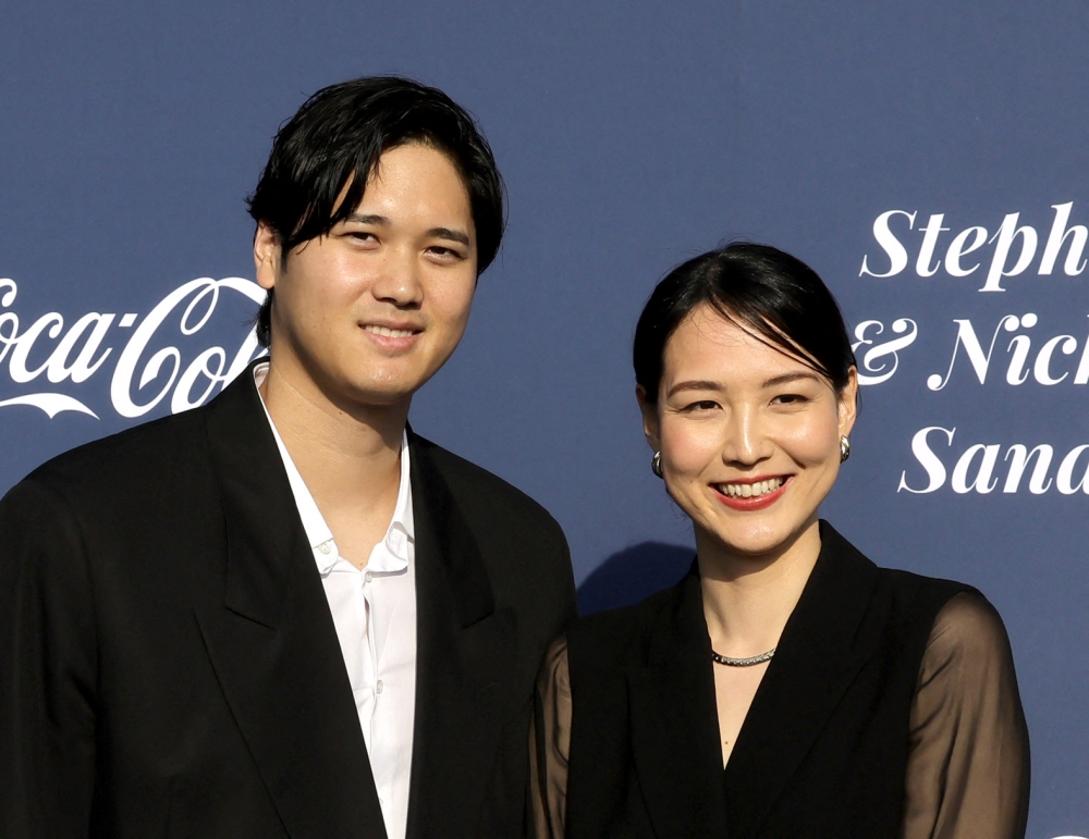 (FILES) Shohei Ohtani (L) and Mamiko Tanaka arrive at the Los Angeles Dodgers Foundation's 2024 Blue Diamond Gala at Dodger Stadium on May 2, 2024 in Los Angeles, California. (Photo by Kevin Winter / Getty Images North America / AFP)