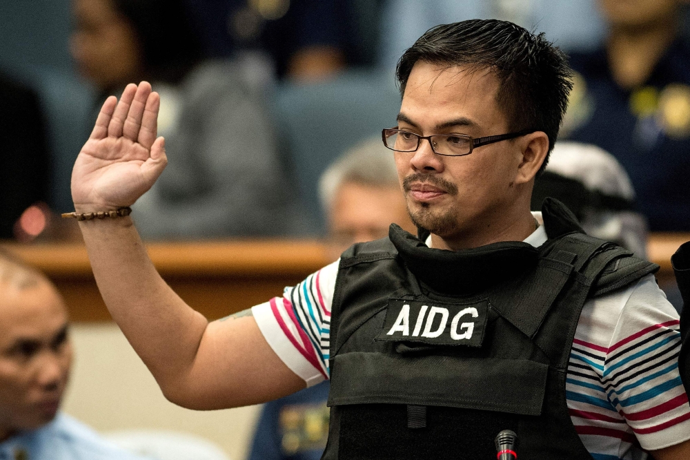 (Files) This file photo taken on November 23, 2016 shows Kerwin Espinosa taking an oath during the Senate drug hearing at the Senate building in Manila. (Photo by Noel Celis / AFP) 