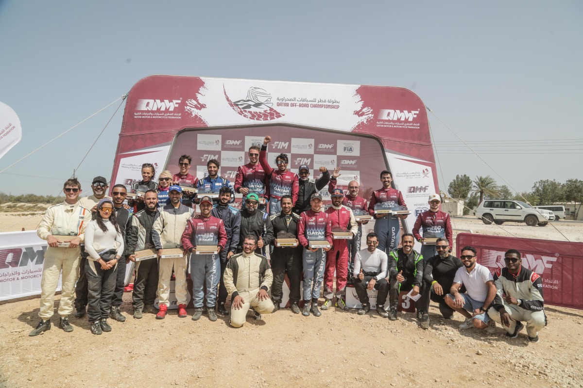 The podium winners pose for a group picture after the  second round of the Qatar Off-Road Championship. 