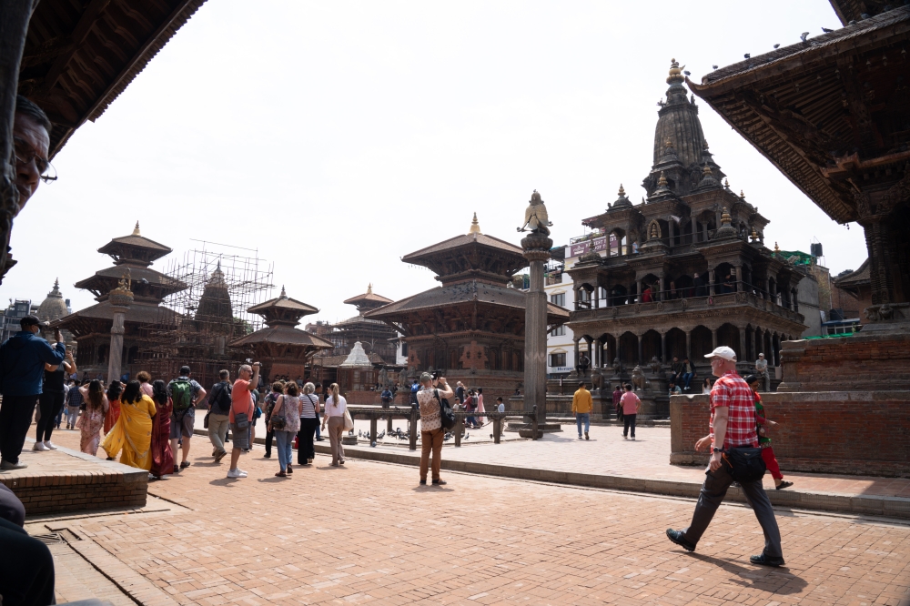 Tourists visit Patan Durbar Square, a UNESCO world heritage site, in Lalitpur, Nepal, April 18, 2025. (Photo by Hari Maharjan/Xinhua)
