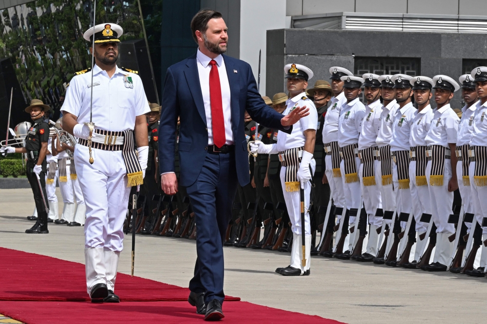 US Vice President JD Vance (C) inspects a guard of honour upon his arrival at the airport in New Delhi on April 21, 2025. (Photo by Kenny HOLSTON / POOL / AFP)