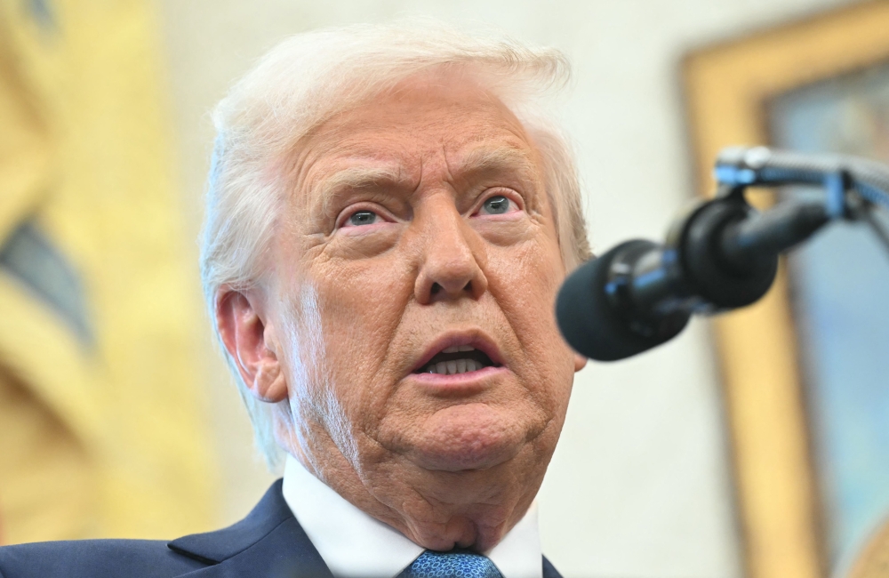 US President Donald Trump speaks to reporters as he participates in the swearing-in ceremony for Paul Atkins, Chairman of the Securities and Exchange Commission (SEC), in the Oval Office of the White House on Washington, DC, April 22, 2025. (Photo by Saul Loeb / AFP)
 