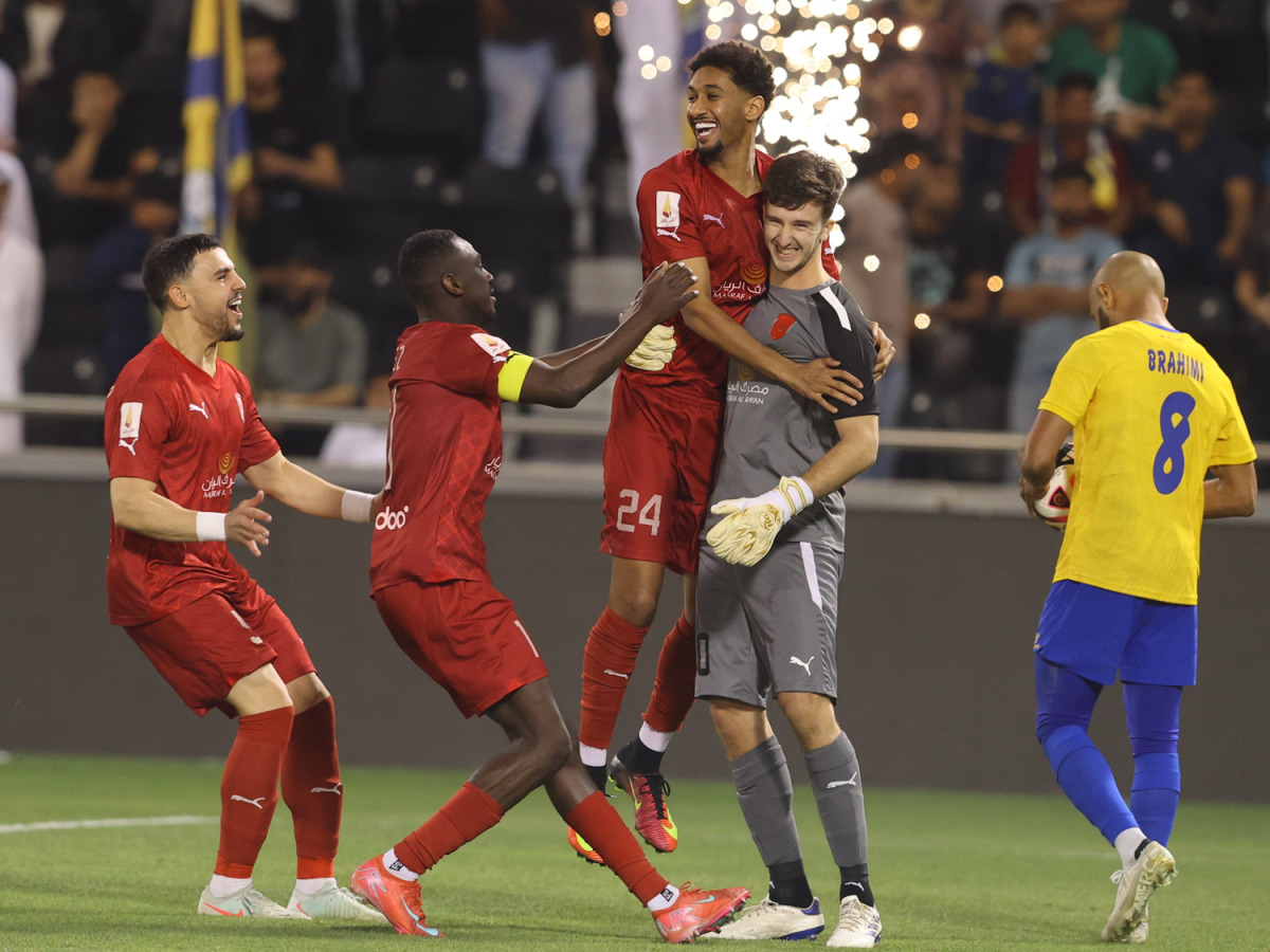 Al Duhail players celebrate with goalkeeper Bautista Burke after the win. 