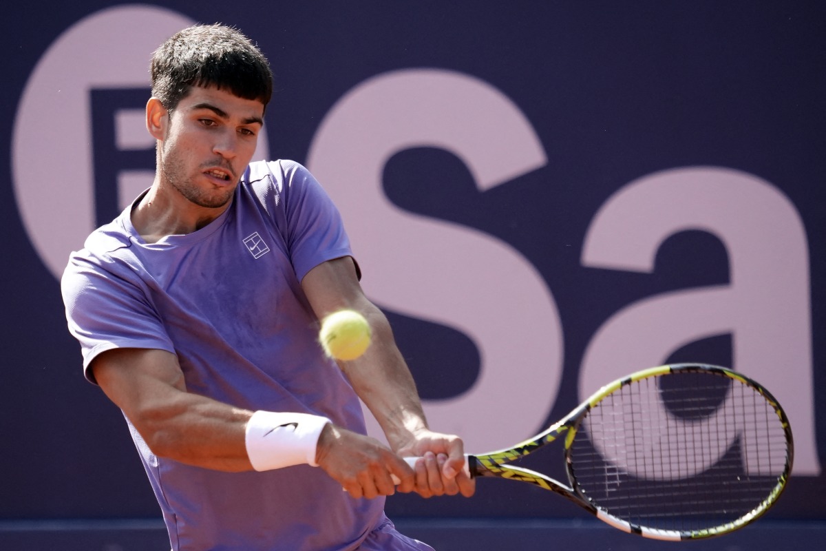Spain's Carlos Alcaraz returns the ball to France's Arthur Fils during the ATP Barcelona Open 