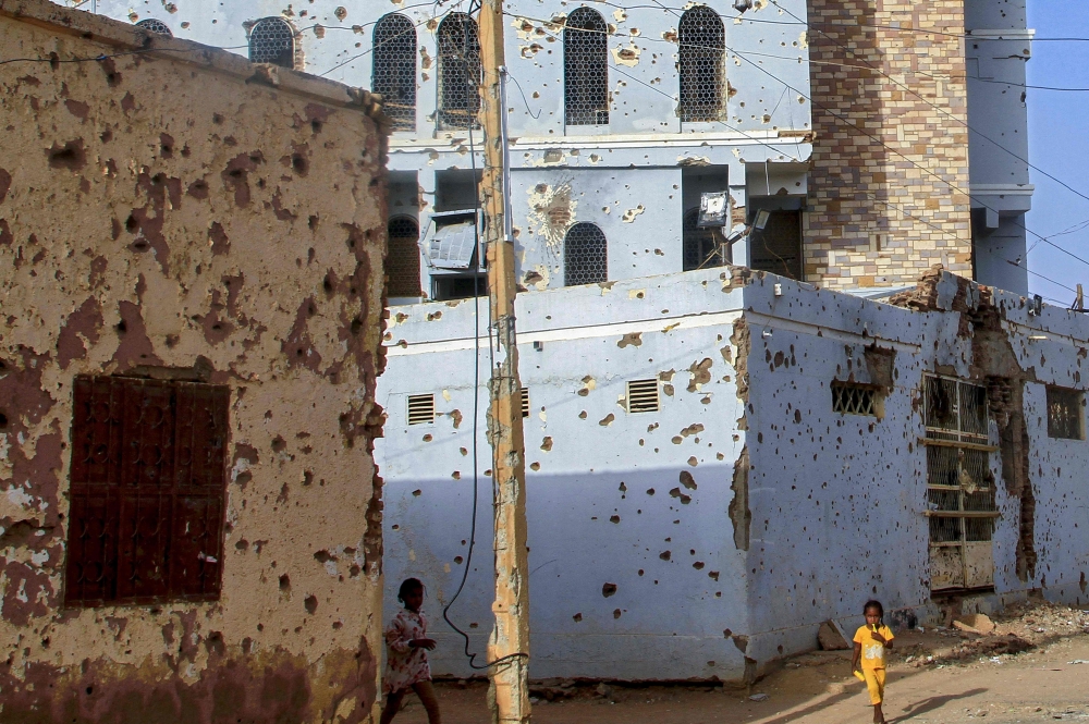 File: A bullet-riddled buildings in Khartoum's twin-city Omdurman on March 20, 2025. (Photo by Ebrahim Hamid / AFP)