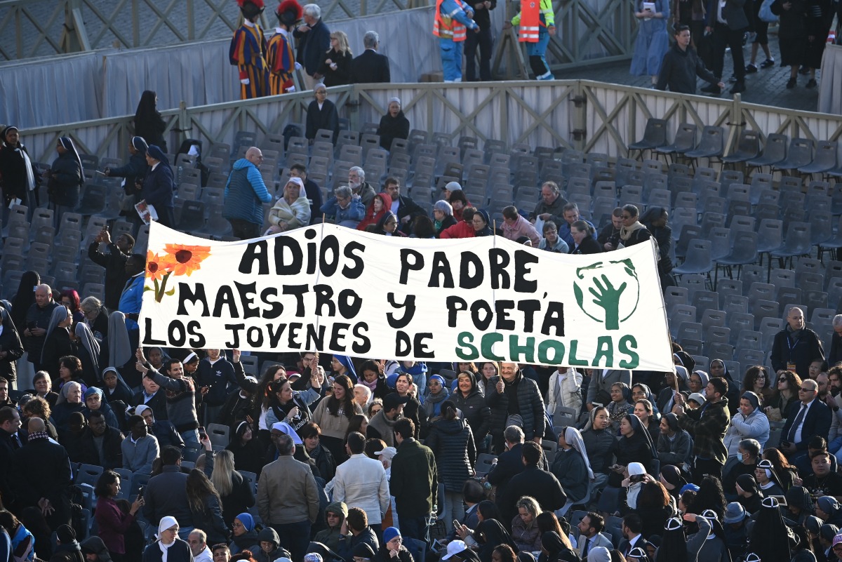 Attendees hold a banner reading 