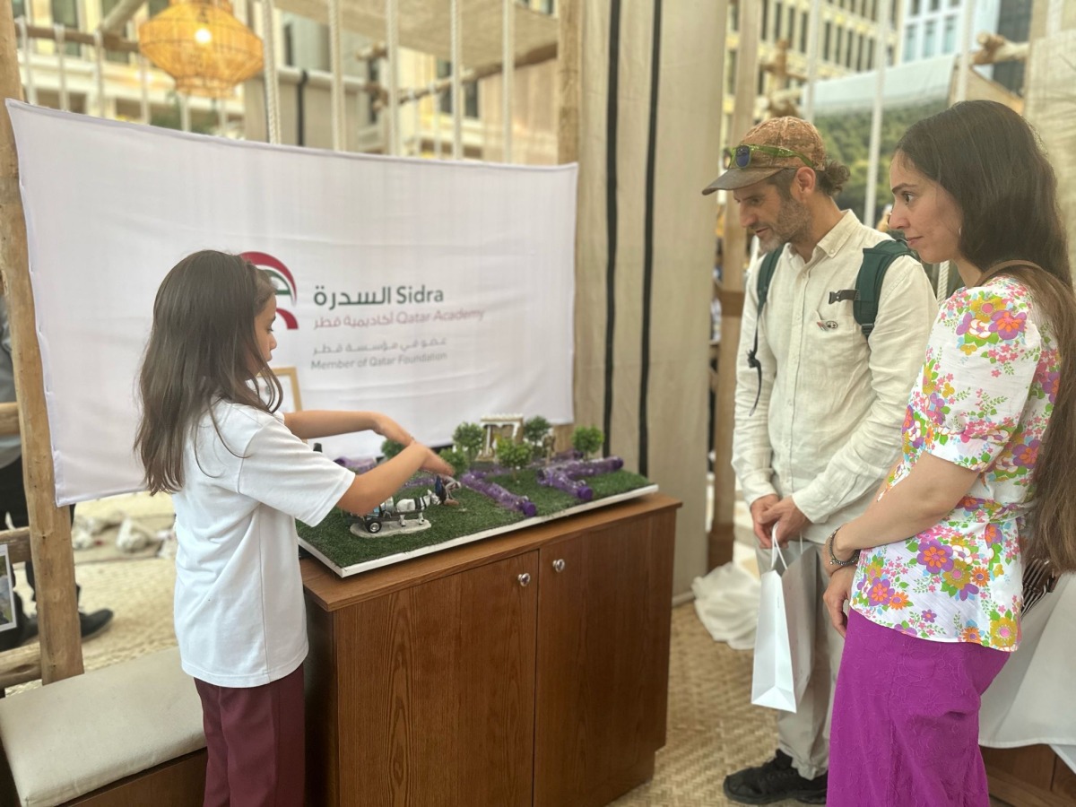 A student displays her project during the Earthna Summit.