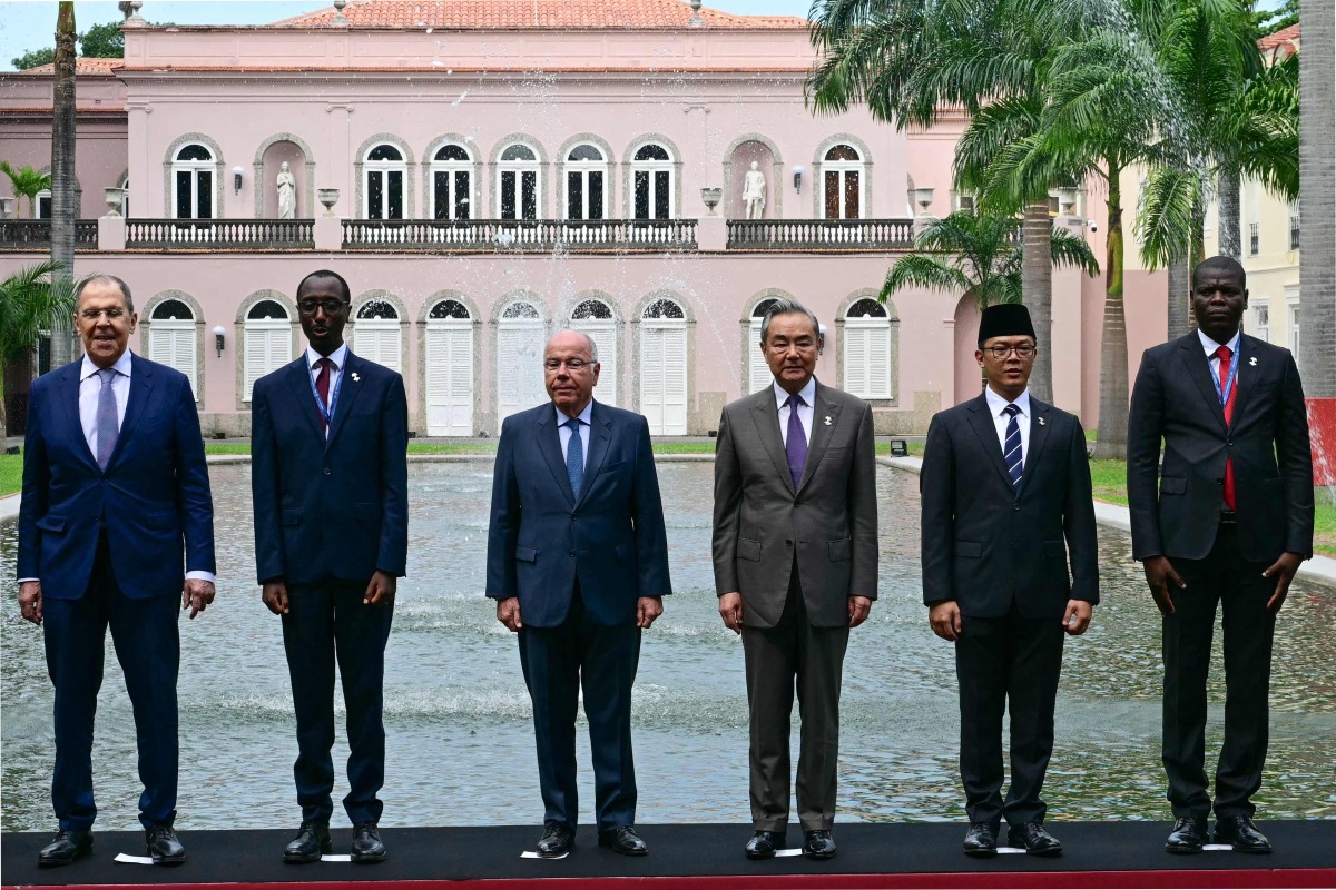 (L to R) Russia's Foreign Minister Sergey Lavrov, Ethiopia's Minister of Foreign Affairs Gedion Timothewos, Brazil's Foreign Minister Mauro Vieira, China's Foreign Minister Wang Yi, Indonesia's Foreign Minister Sugiono and South Africa's Minister of Foreign Affairs Ronald Lamola pose for the family photo at the first meeting of BRICS Foreign Ministers in Rio de Janeiro, Brazil, on April 28, 2025. (Photo by Pablo PORCIUNCULA / AFP)
