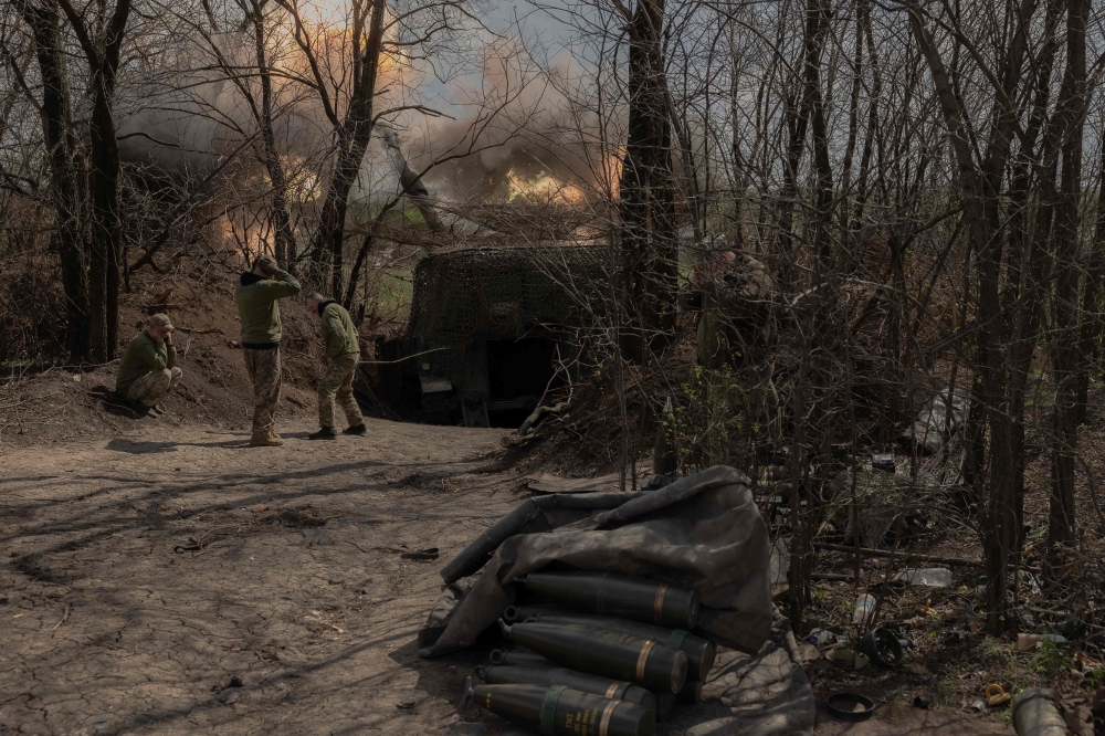 Ukrainian servicemen of the Skala regiment artillery unit fire an M109 howitzer toward Russian positions, in an undisclosed area, in the eastern Donetsk region, on April 23, 2025. (Photo by Roman Pilipey / AFP)