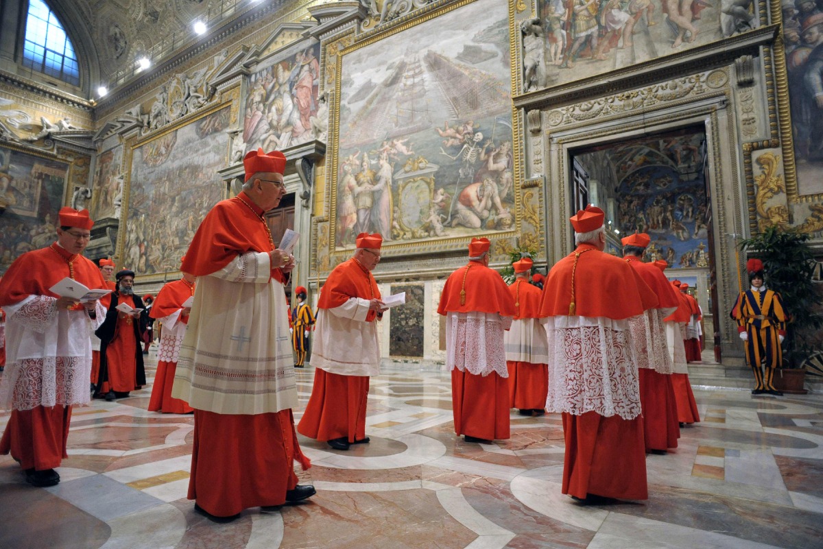 This handout picture released by the Press office shows cardinals entering in the Sistine Chapel before the start of the conclave at the Vatican on March 12, 2013. Photo by Handout / OSSERVATORE ROMANO / AFP