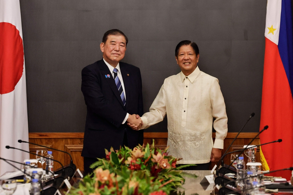 Japan's Prime Minister Shigeru Ishiba (left) and Philippine President Ferdinand Marcos before the start of a bilateral meeting at the Malacanang Palace in Manila on April 29, 2025. (Photo by Rolex Dela Pena / POOL / AFP)