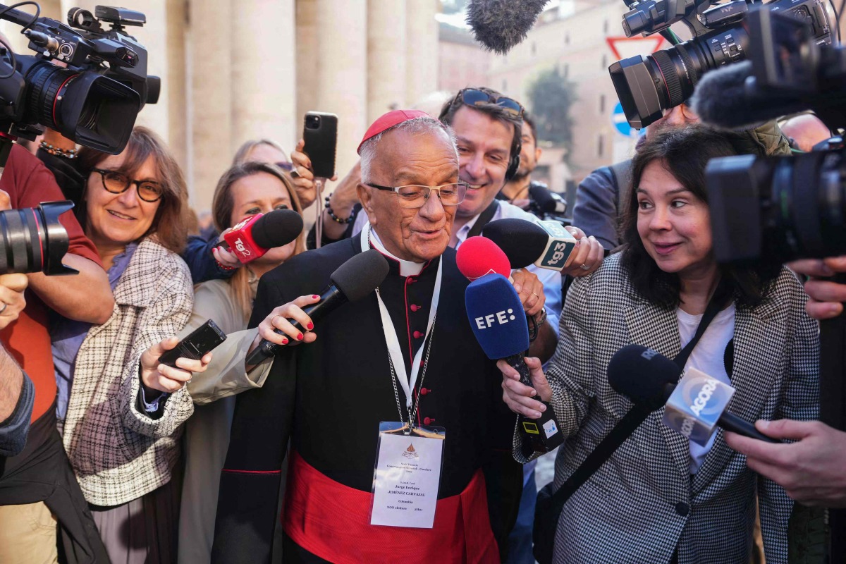 Colombian cardinal Jorge Enrique Jiménez Carvajal (C) speaks to the press as he arrives for the seventh congregation meeting at The Vatican, on April 30, 2025. (Photo by Dimitar DILKOFF / AFP)
