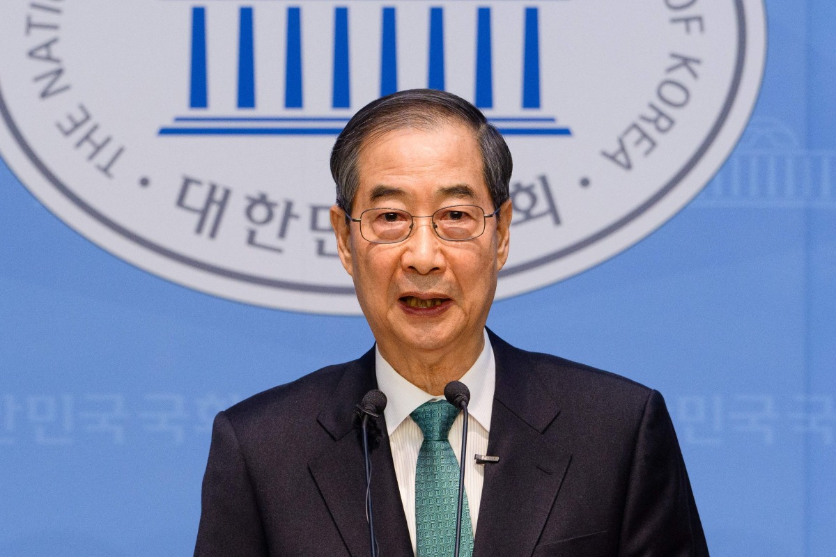 Former acting president Han Duck-soo speaks to formally announce his candidacy for the presidential election at the National Assembly in Seoul on May 2, 2025. (Photo by ANTHONY WALLACE / AFP)