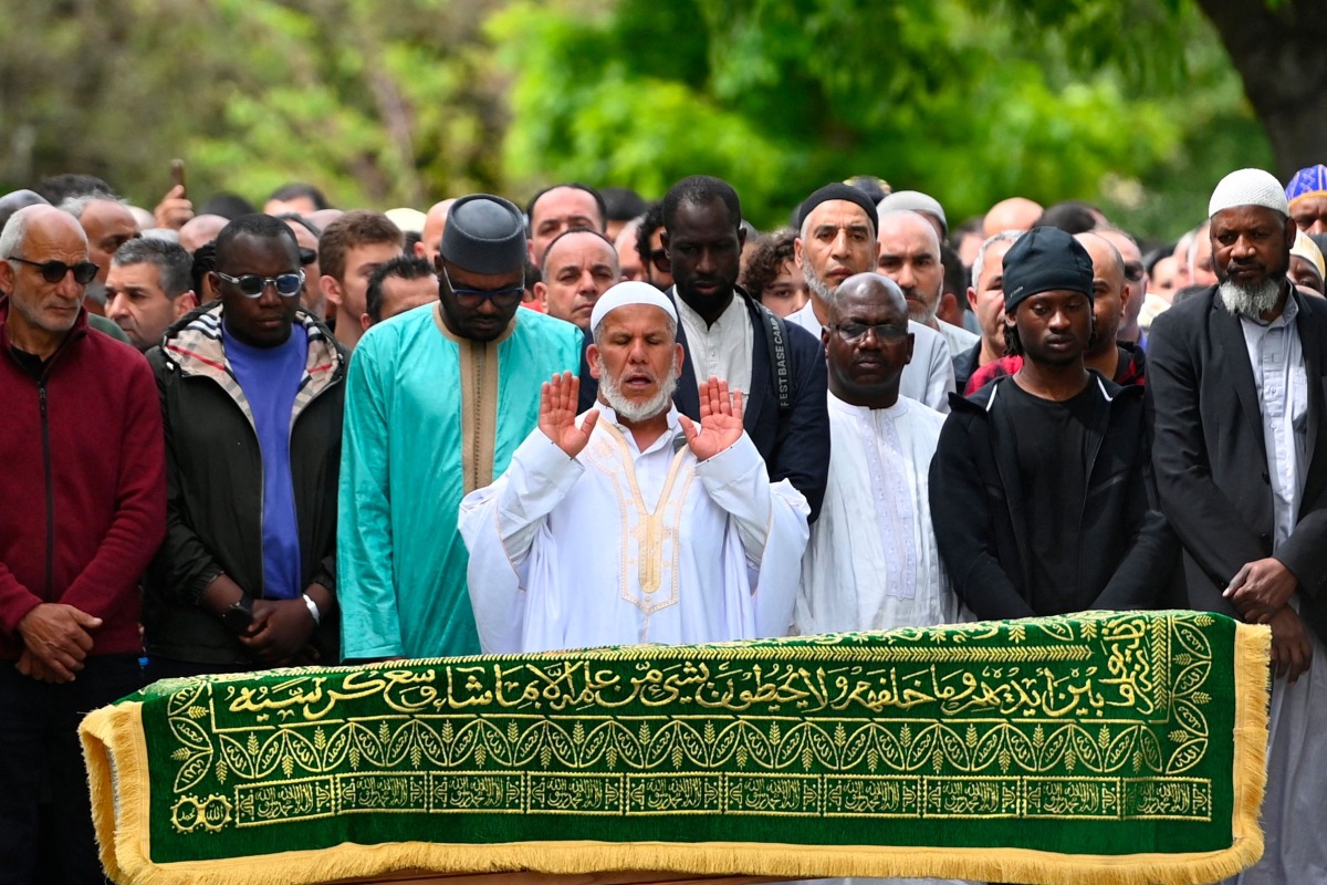 President of the Khadija Mosque, Salim Touazi (C) prays before the coffin of Aboubakar Cisse, a worshipper killed by dozens of stab wounds inside the mosque on April 25th, as part of his funeral prayer, outside the Khadija Mosque in La Grand-Combe, southern France, on May 2, 2025. (Photo by Sylvain THOMAS / AFP)
