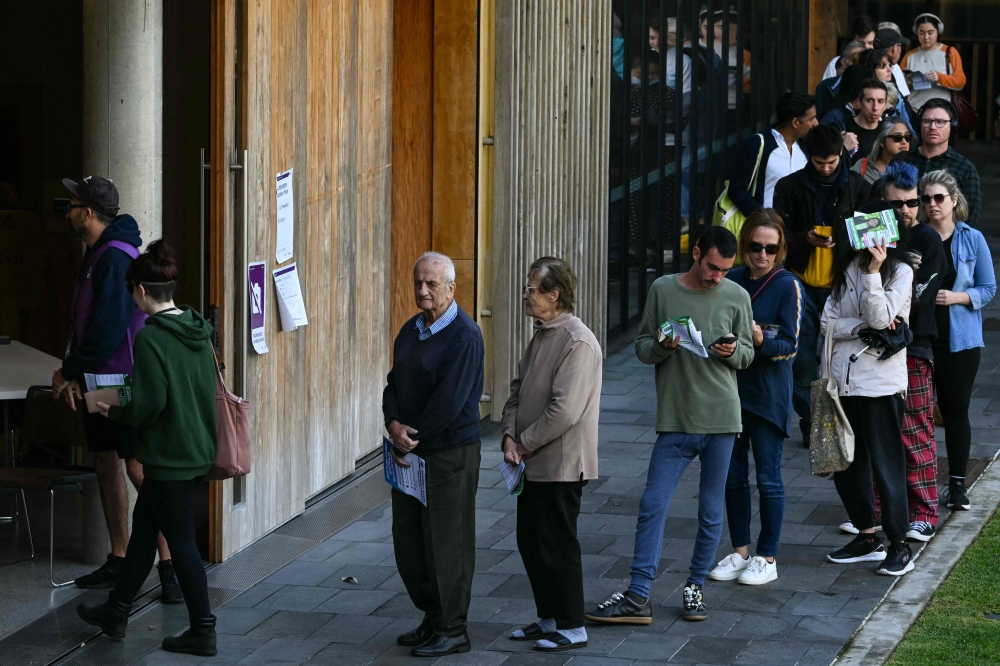 People queue to vote in Australia's general election at a polling station in the suburb of Marrickville in Sydney on May 3, 2025. (Photo by Saeed Khan / AFP)
