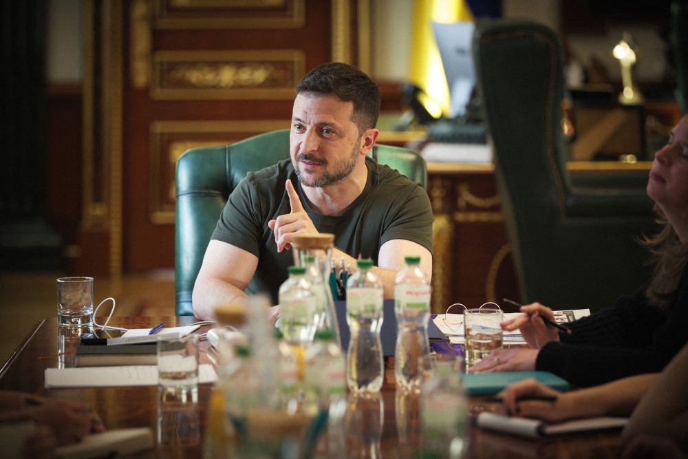 This handout photograph by Ukrainian presidential press-service taken on May 2, 2025 and released on May 3, 2025 shows Ukrainian president Volodymyr Zelensky (C) talking with journalists during a press conference in Kyiv. (Photo by Handout / UKRAINE PRESIDENCY / AFP)