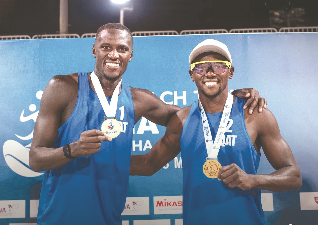 Qatar’s Cherif Younousse and Ahmed Tijan celebrate with their medals.