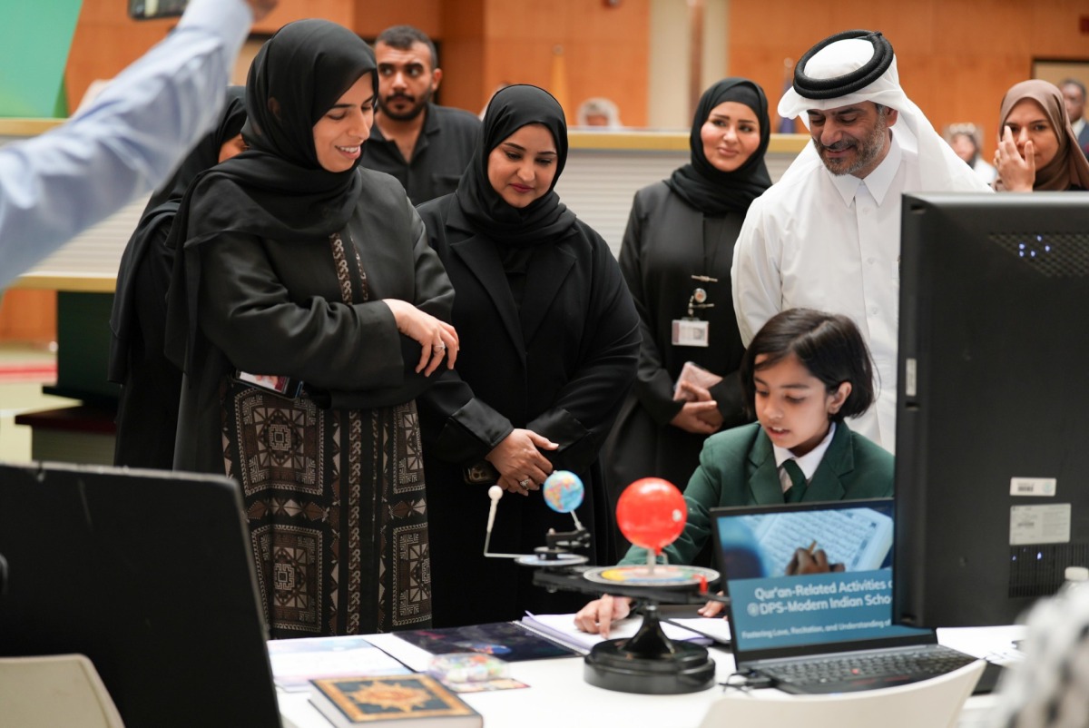 Minister of Education and Higher Education H E Lolwah bint Rashid bin Mohammed Al Khater interacting with a student at the event.