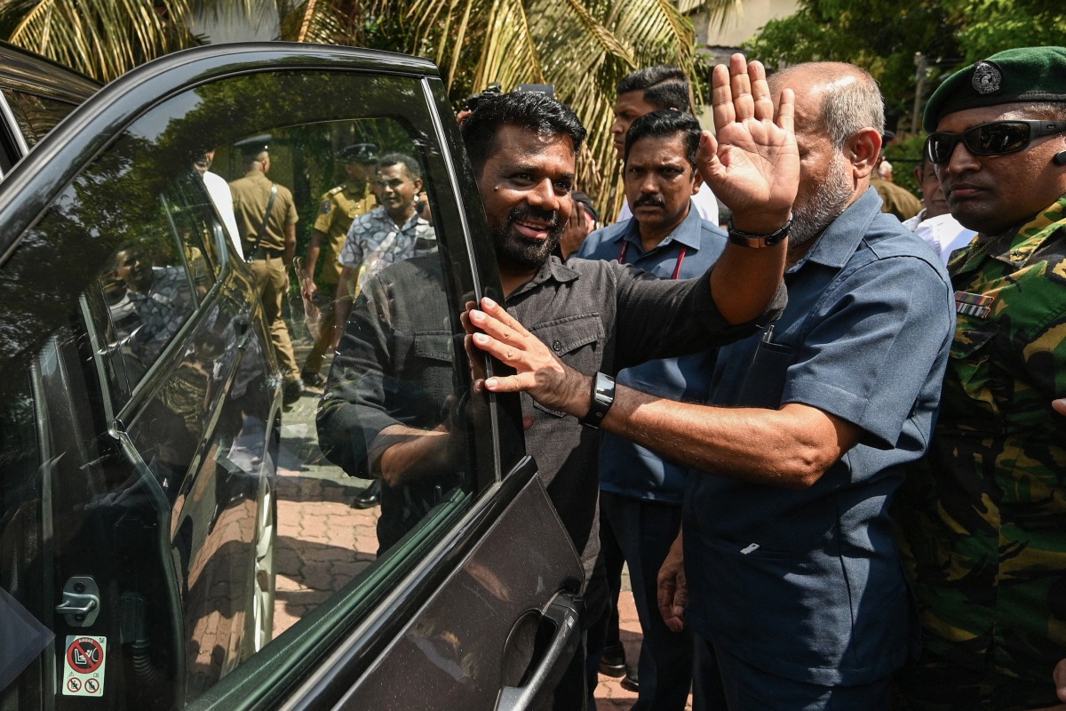 Sri Lanka's President Anura Kumara Dissanayake (C) waves as he leaves a polling station after casting his ballot during voting in Sri Lanka's local government election in Colombo on May 6, 2025. (Photo by Ishara S. KODIKARA / AFP)