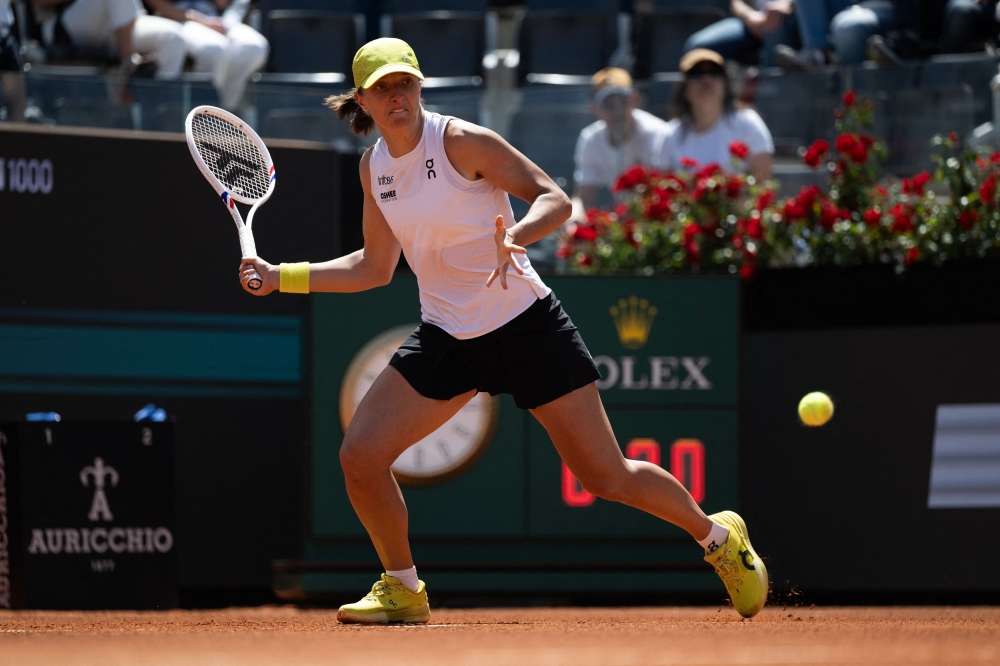 Poland's Iga Swiatek returns the ball to Italy's Elisabetta Cocciaretto during their match of the WTA Rome Open tennis tournament at the Foro Italico in Rome, on May 8, 2025. (Photo by Marco Bertorello / AFP)