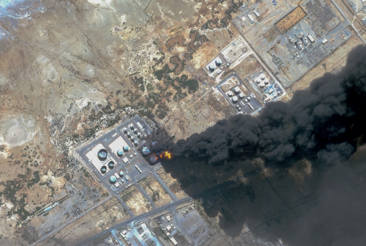 This handout satellite photo obtained from Planet Labs PBC and dated May 6, 2025, shows smoke billowing from a fuel storage depot after a strike on Port Sudan. (Photo by Planet Labs PBC / AFP)