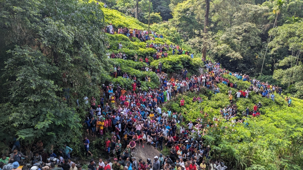 People gather near the site of a bus accident in Kotmale, Sri Lanka on May 11, 2025.  (Photo by Gayan Sameera/Xinhua)