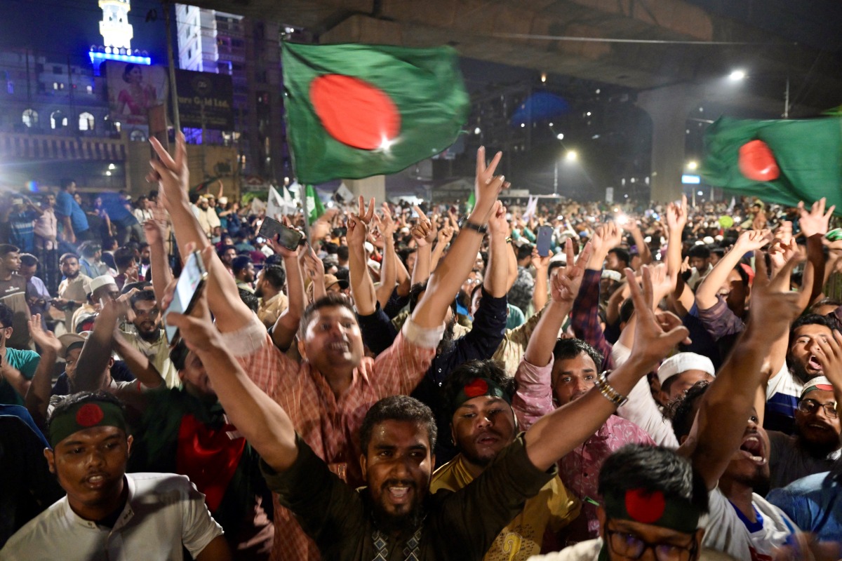 Bangladeshis celebrate after the interim government officially banned all activities of the Awami League (AL) under the Anti-Terrorism Act, pending the conclusion of the International Crimes Tribunal (ICT) trials against the party and its leaders, in Dhaka on May 10, 2025. (Photo by MUNIR UZ ZAMAN / AFP)