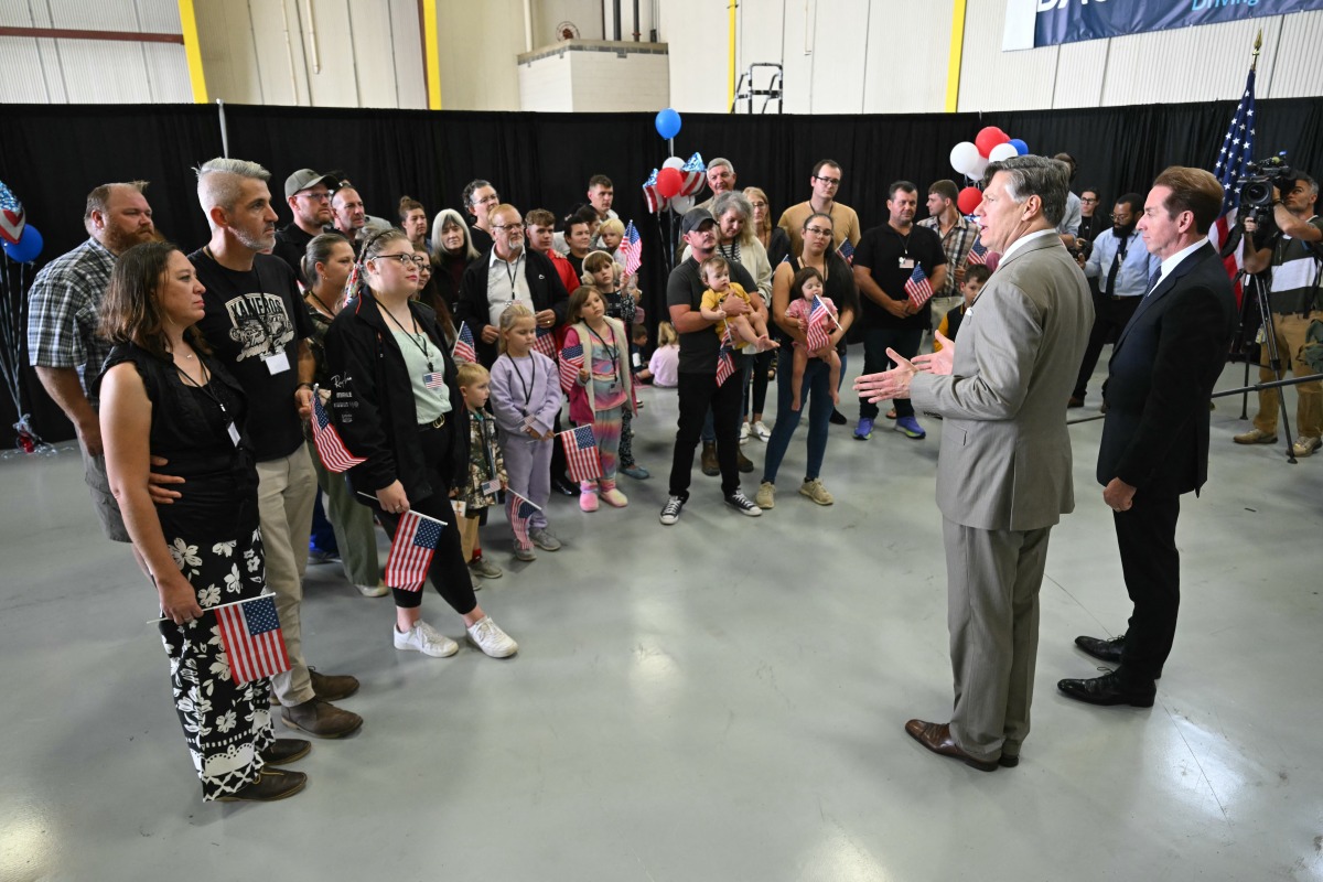 The first group of Afrikaners from South Africa to arrive for resettlement listen to remarks from US Deputy Secretary of State Christopher Landau (2nd R) and US Deputy Secretary of Homeland Security Troy Edgar (R), after they arrived at Washington Dulles International Airport in Dulles, Virginia, on May 12, 2025. (Photo by SAUL LOEB / AFP)