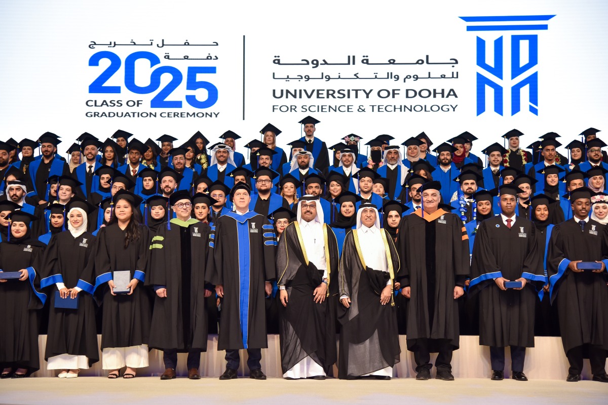 Chairman of UDST Board of Trustees Dr. Mohammed bin Saleh Al-Sada and UDST President Dr. Salem Al-Naemi with faculty and students during a graduation ceremony. 