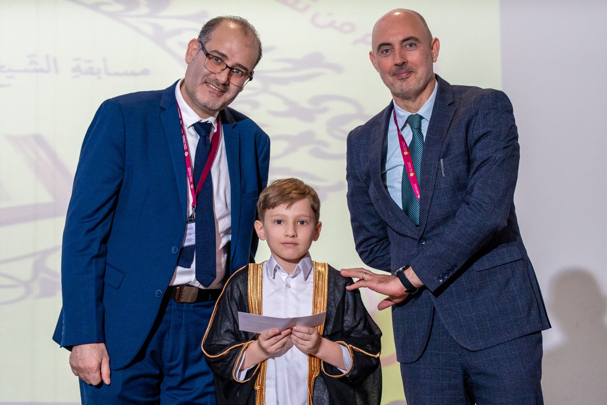 Officials with a winning student. 