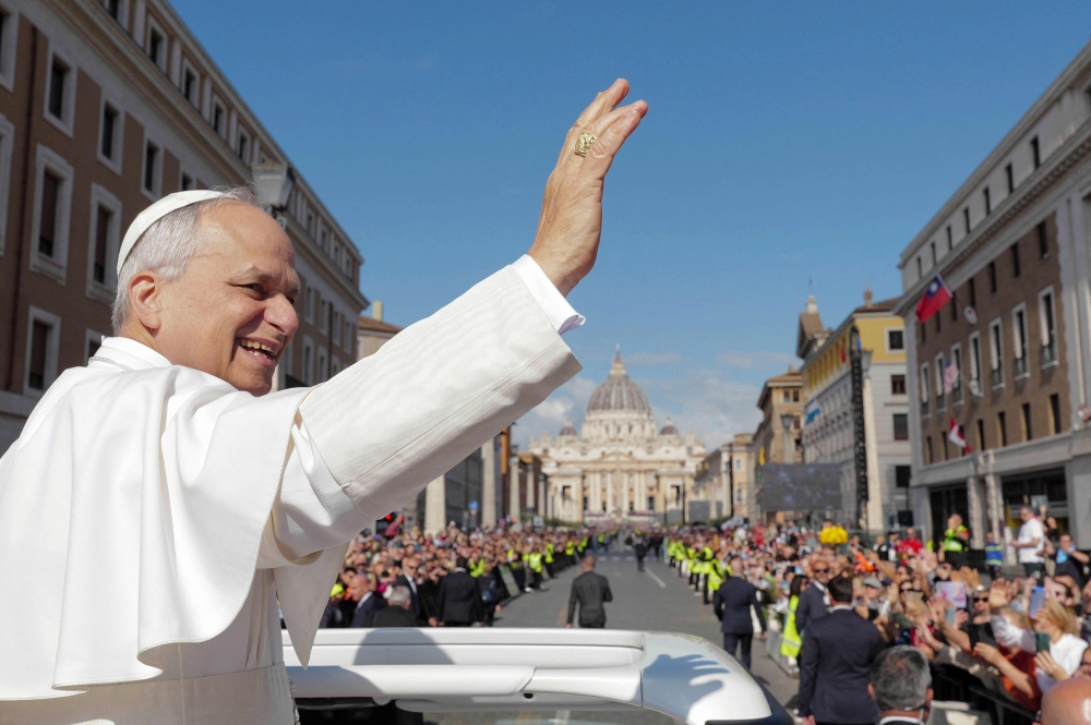 This photo taken and handout on May 18, 2025 shows Pope Leo XIV greeting the crowd from the Pope mobile before a Holy mass for the beginning of his pontificate, in St Peter's square in The Vatican. (Photo by Handout / Vatican Media / AFP) 