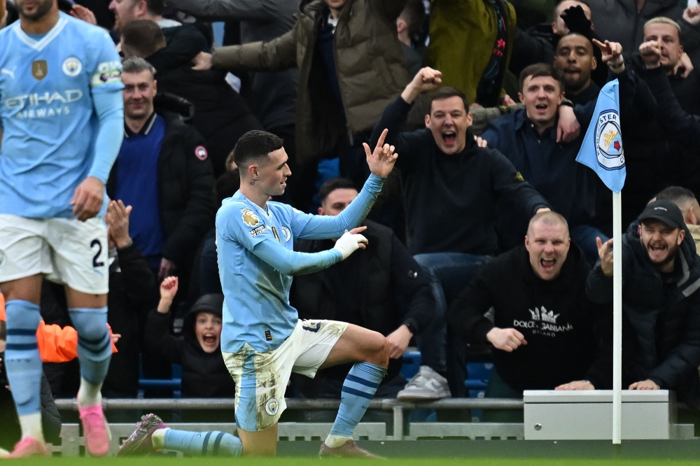 Manchester City's English midfielder #47 Phil Foden celebrates after scoring their second goal during the English Premier League football match between Manchester City and Manchester United at the Etihad Stadium in Manchester, north west England, on March 3, 2024. (Photo by Paul ELLIS / AFP)