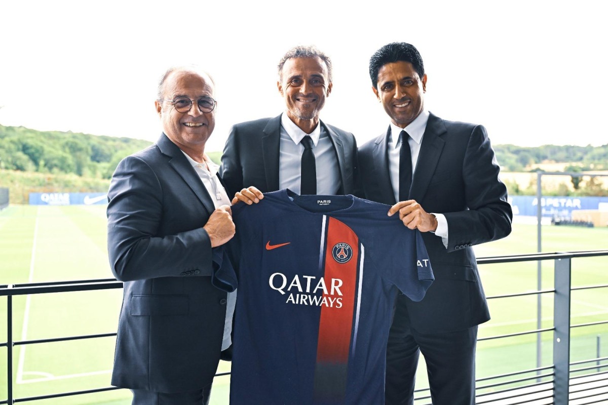 Qatar Sports Investments Chairman Nasser Al-Khelaifi (right), PSG coach Luis Enrique (centre) and QSI Sports Advisor Luis Campos hold a PSG jersey. 