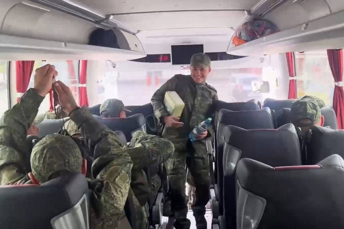 In this video grab taken from a handout footage released by the Russian Defence Ministry on May 24, 2025, a Russian prisoner of war (POW) reacts as he takes his seat in a bus following an exchange at an undisclosed location in Belarus. (Photo by Russian Defence Ministry / AFP)