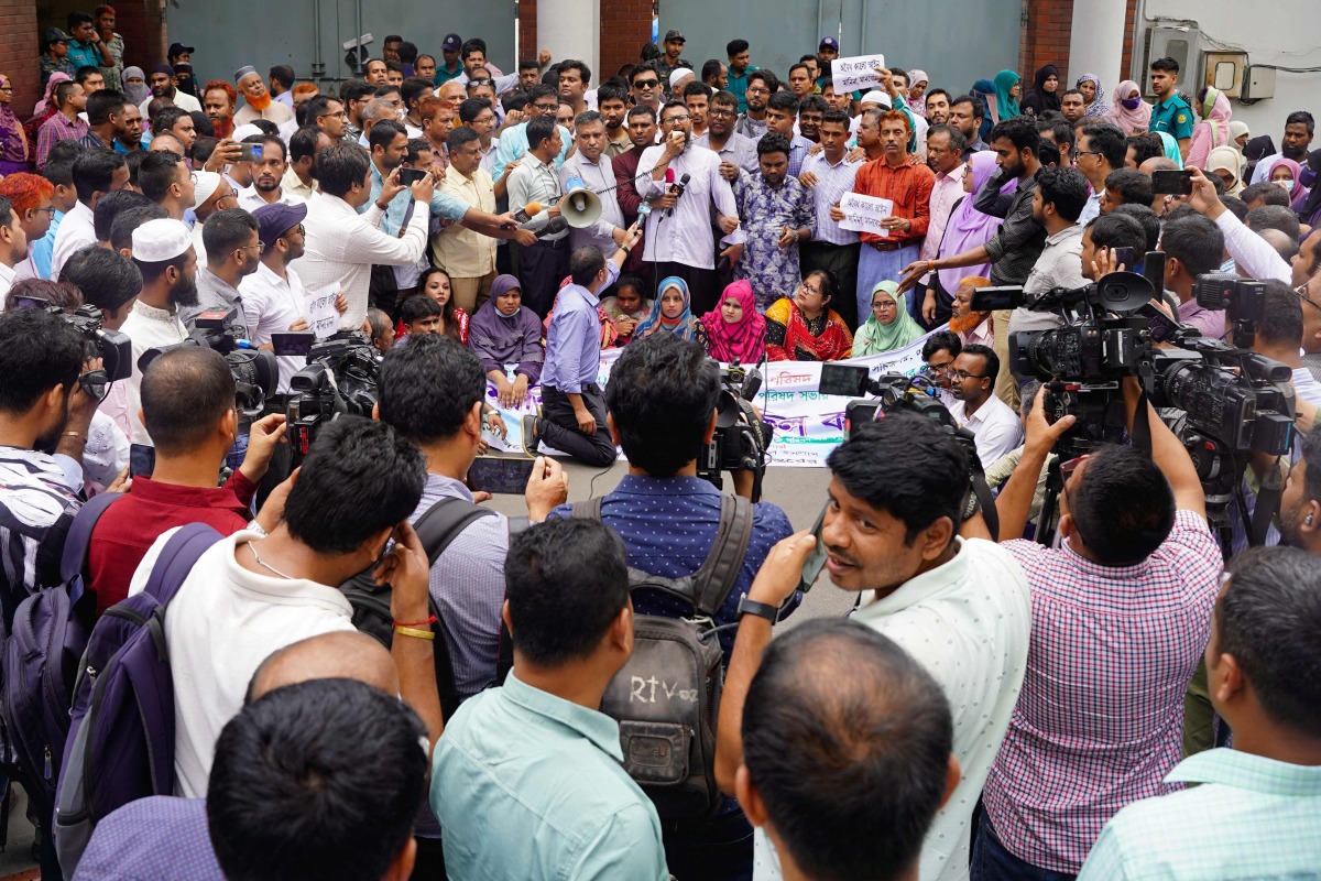 Civil officials stage a demonstration inside the Secretariat building in Dhaka on May 25, 2025, demanding the repeal of a government order giving it greater power to sack employees for disciplinary breaches. (Photo by AFP)